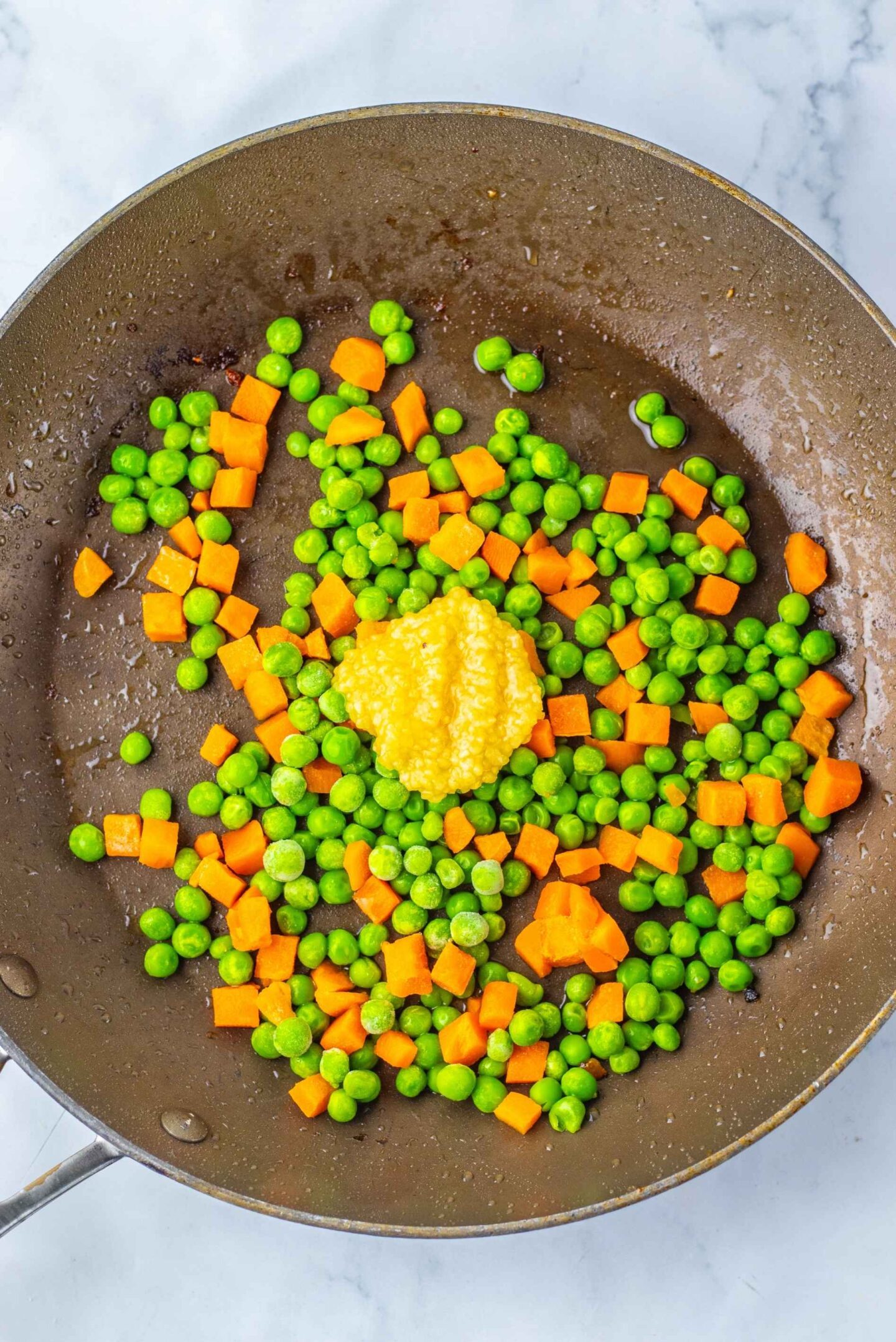 peas and carrots in pan