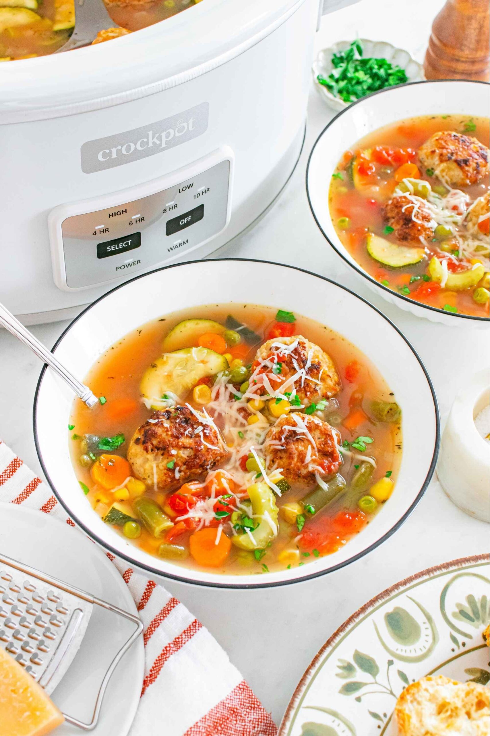 slow cooker veg and chicken meatball soup in bowls