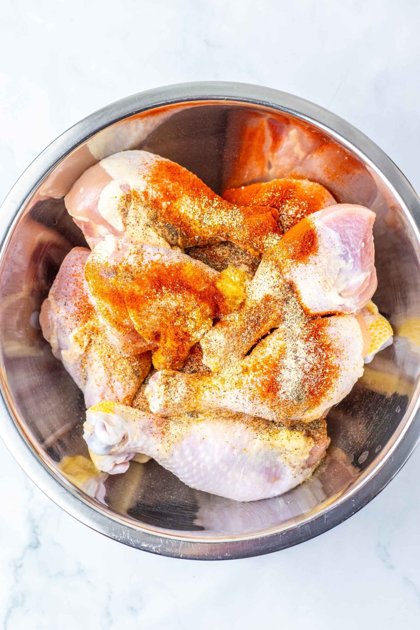 orange chicken legs in seasoning