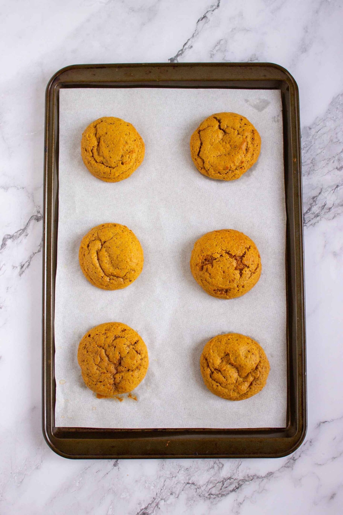 baked pumpkin cookies on tray