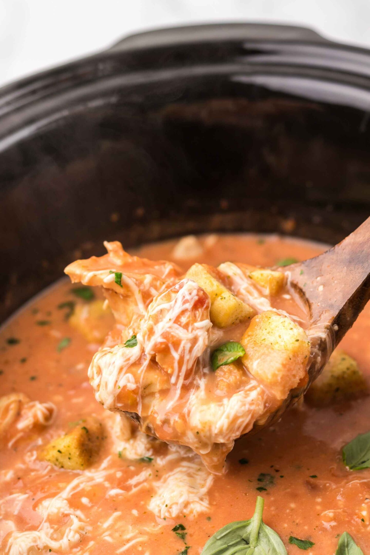 chicken parmesan soup on spoon