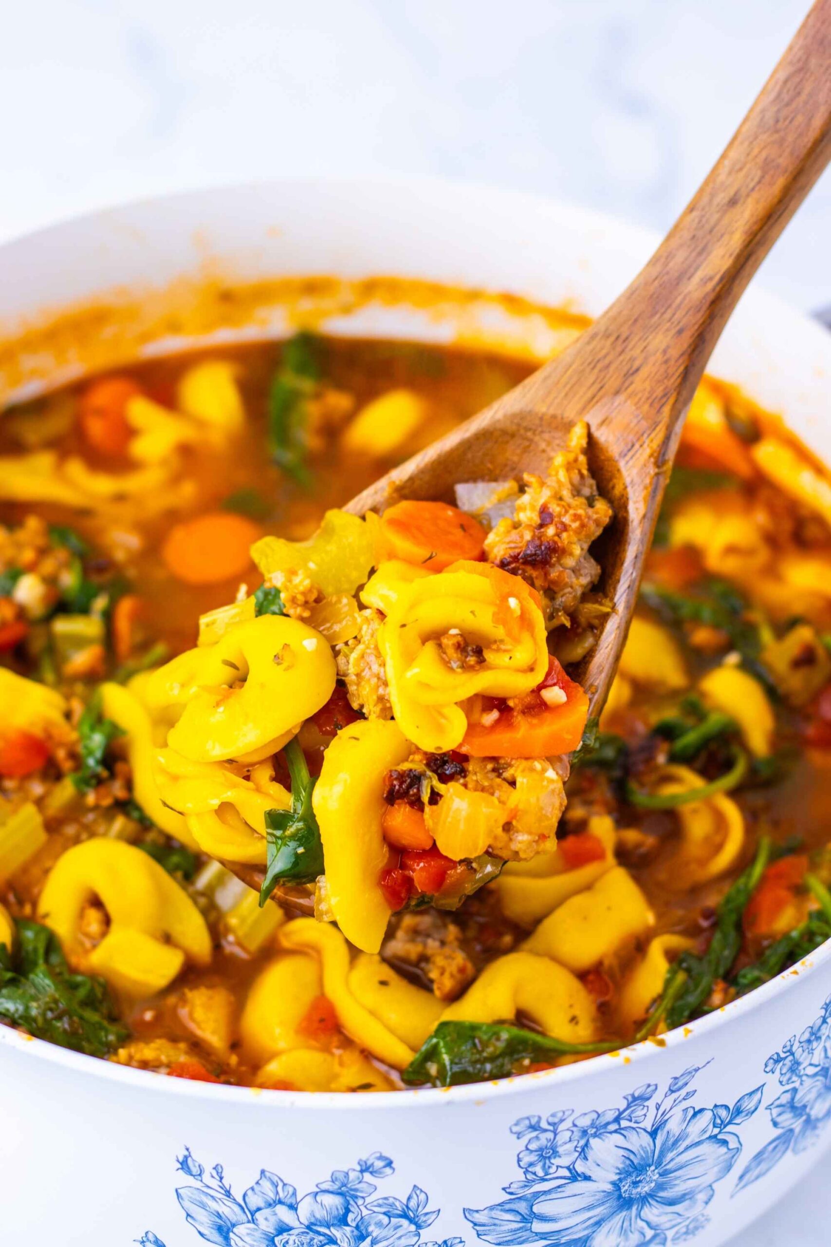 tortellini soup on spoon